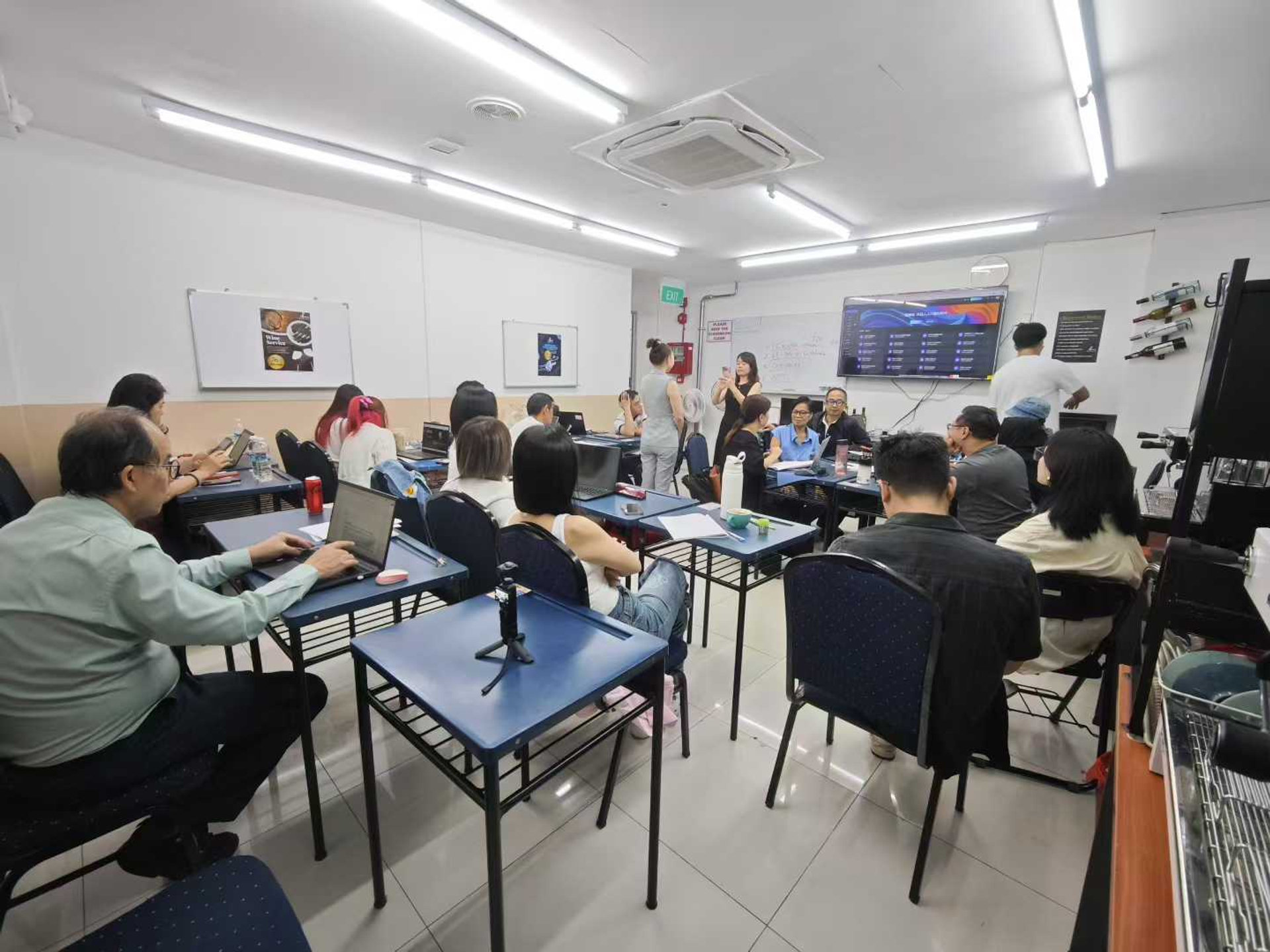 AI training classroom session with participants working on laptops